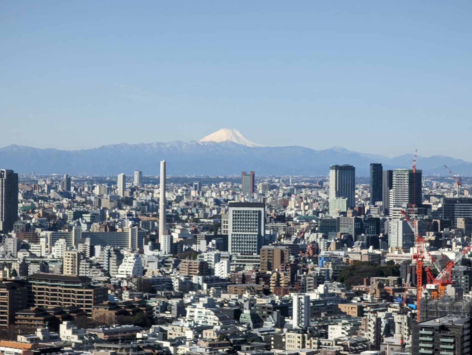 Tokyo skyline at dusk with high-rise towers stretching to the horizon